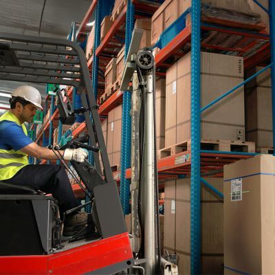 Forklift driver scans SSCC code on cardboard box Forklift driver scans SSCC code on cardboard box