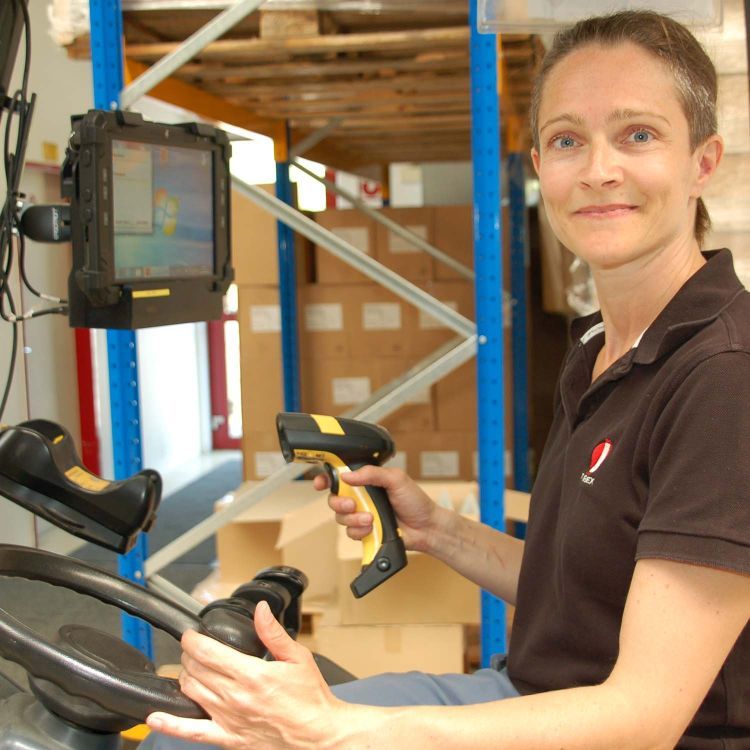 Tubex employee with barcode scanner in forklift truck Tubex employee with barcode scanner in forklift truck